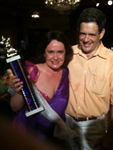 Dean Maguire and her husband, Raymer III, with her First Place trophy.